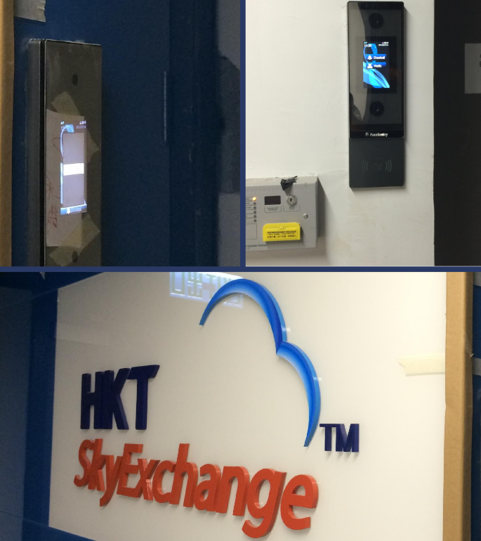 A biometric access control panel is mounted on a wall above a power box, with an HKT Sky Exchange logo sign displayed nearby.